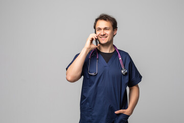 Portrait of successful doctor talking on phone. Smiling medical doctor with stethoscope talking on...