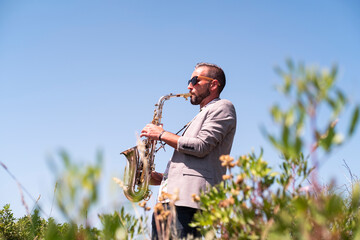Musician playing saxophone outdoors