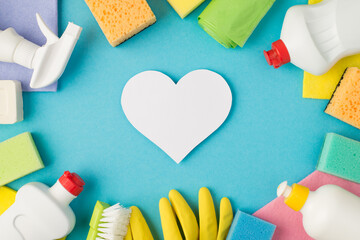 Above photo of equipment for cleaning and card heart in the middle isolated on the blue background