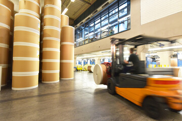 Storage of paper rolls in a large print shop - transport with a forklift truck