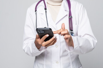 Portrait of a beautiful smiling nurse or Doctor woman use the phone to get treatment isolated on white background