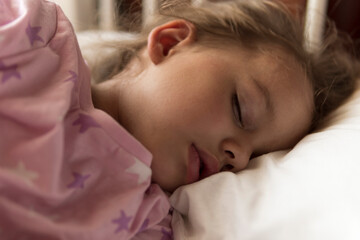 Cute cheerful little 3-4 years preschool baby girl kid sleeping sweetly in white crib during lunch...