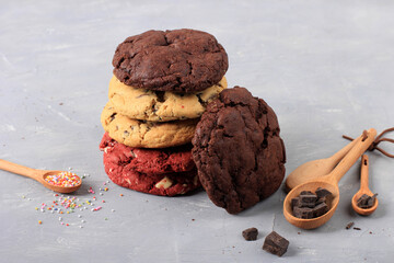 Stackable Various Soft American Cookies, Vanilla, Red Velvet and Dark Chocolate Chips on Rustic Table. Copy Space for Text or Recipe