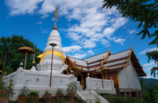 white pagoda at Wat Phra That Doi Leng Temple on the Mountain with blue sky, travel attraction in Phrae, Thailand