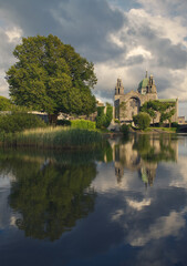 Fototapeta na wymiar Beautiful scenery of Galway cathedral by the canal of Corrib river with reflecions in the water in Ireland 