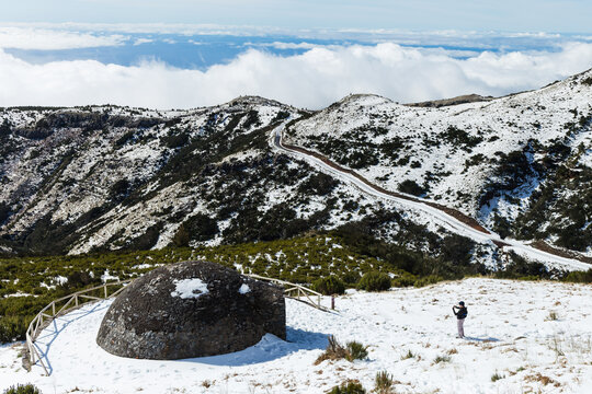 Adult male taking pictures to Poco da Neve at Pico do Areeiro mountain covered with snow in Madeira island, Portugal.