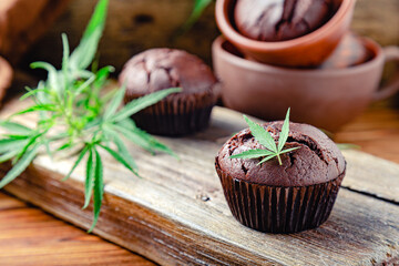 Chocolate cupcake muffins with cannabis leaves, weed cbd. Medical marijuana hemp drugs in food...