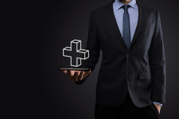 Businessman hold 3D plus icon, man hold in hand offer positive thing such as profit, benefits, development, CSR represented by plus sign.The hand shows the plus sign