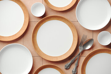 Mockup background for food stylist presentation. Top view of empty plates with tableware setting on beige terracotta background. 3d render illustration. Clipping path of each element included.