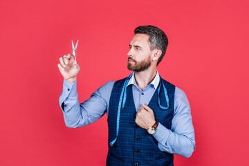 professional tailor with scissors and measuring tape. fashion designer. man individual tailoring.