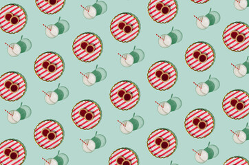 Colorful pattern with milk glasses and tasty cookies on a pastel green background. Uplifting morning creative idea.
