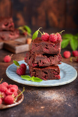 Brownie bars with dark chocolate and raspberries. Delicious summer homemade cake. 