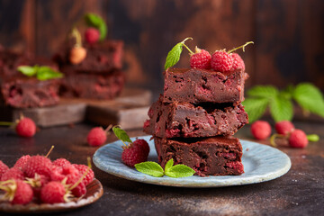 Brownie bars with dark chocolate and raspberries. Delicious summer homemade cake. 