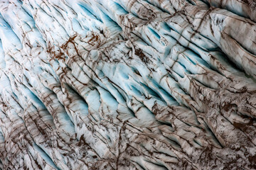 Glacier crevasses detail closeup ice pattern abstract background from above