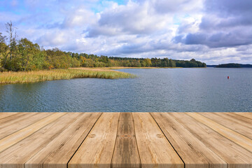 Autumn landscape with wooden planks floor on foreground - obrazy, fototapety, plakaty