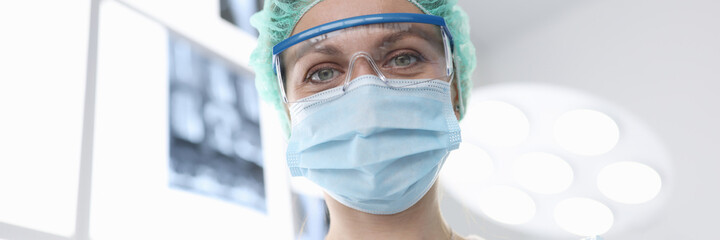 Woman surgeon in sterile suit in operating room