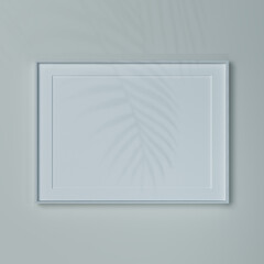 Empty gorizontal frame on a wall in natural light. Mockup of a picture or poster A2 in white wooden...