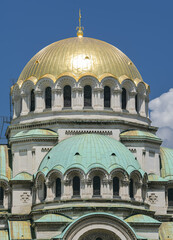 Fototapeta na wymiar Landmarks of Bulgaria. Alexandr Nevski Cathedral in Sofia during a beautiful summer day with blue sky and white clouds. Touristic attraction.
