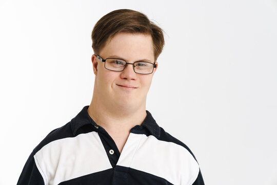 Young Man With Down Syndrome Smiling And Looking At Camera