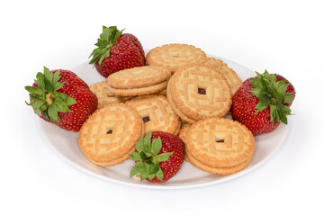 Sandwich cookies with strawberry jam filling among the fresh strawberries