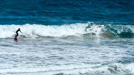 Surfing in Las Canteras Beach, in Las Palmas City