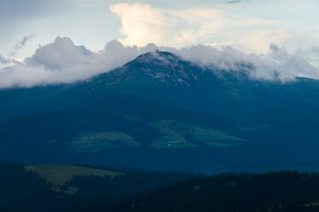 Lonely mountain behind the clouds