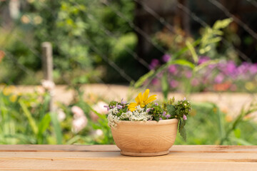 a beautiful clay vase stands on a wooden table. summer garden. field bouquet of flowers.