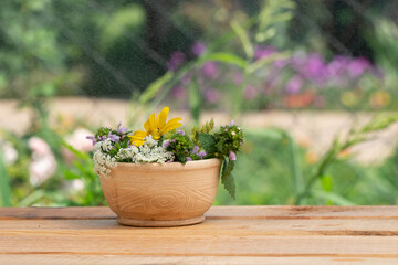a beautiful clay vase stands on a wooden table. summer garden. field bouquet of flowers.