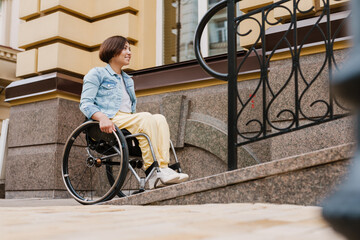 Mid aged brunette disabled woman sitting in a wheelchair