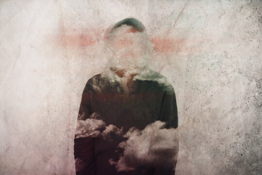 A mental health concept. Of a man with his head covered in clouds.  With a grunge, artistic edit