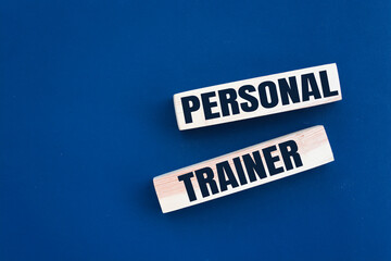 Personal trainer text from wooden blocks on desk