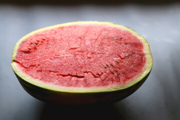 Half of watermelon on dark background. Selective focus.