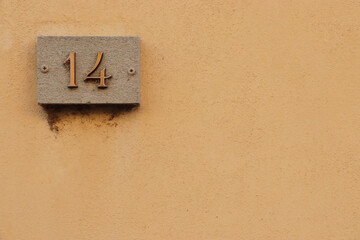 Street number sign, number fourteen on the top left corner
