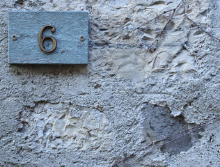 Street number sign, number six on the top left corner