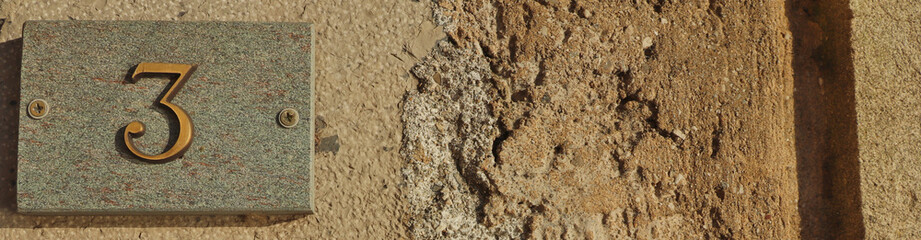 Number three on a wall on the left sid, banner