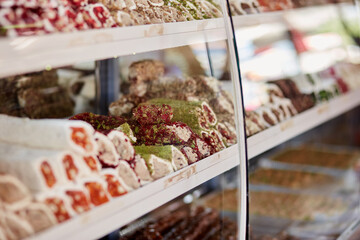 Large selection of Turkish delight in the store. An assortment of colorful Turkish delight and baklava. Turkish National Classic Dessert