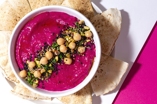 Tasty beetroot hummus in bowl on table