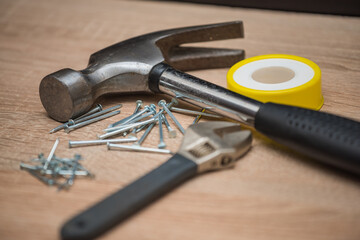 hammer and nails on wood,  wrench