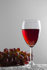 red wine and grapes on white background