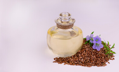 Flaxseed oil on white background. Source of omega-3, natural antioxidant. Copy space.