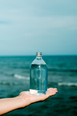 has a reusable bottle full of water in his hand