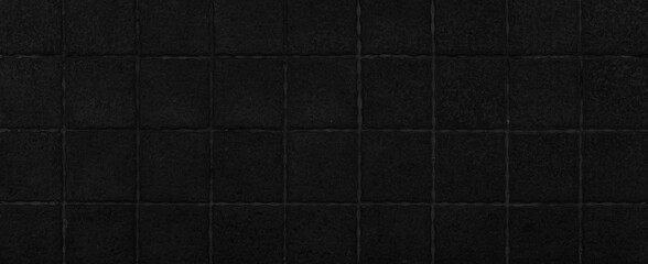 Fototapeta premium Panorama of Black granite tiled wall with vintage pattern texture and background seamless