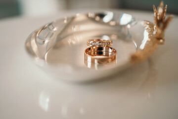 Wedding rings close-up. Two beautiful rings at the barque ceremony. Soft focus. Picture with blurry background.