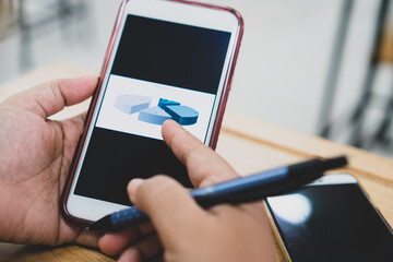 Businessman hold phone checking graphs diagrams on screen smartphone for Startup analyzing in project statistics, Using mobile check document report presentation corporate working in new normal