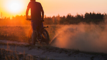 A rider on a powerful modern electric mountain bike rides on the sand. Slip in the sand