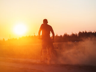 A rider on a powerful modern electric mountain bike rides on the sand. Slip in the sand