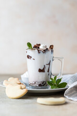 Holiday hot chocolate or cocoa with marshmallow and cinnamon served with homemade butter cookies.