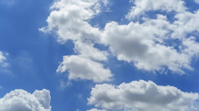 Puffy fluffy white clouds cloudscape timelapse with blue sky background. Natural white clouds background.