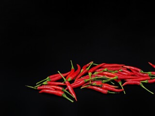 Fototapeta na wymiar chili peppers on a black background