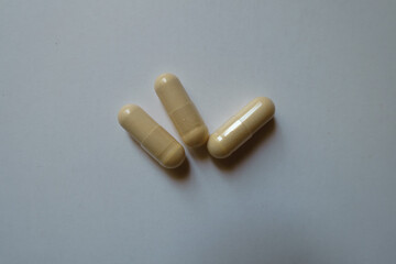 Top view of three beige capsules of milk thistle extract